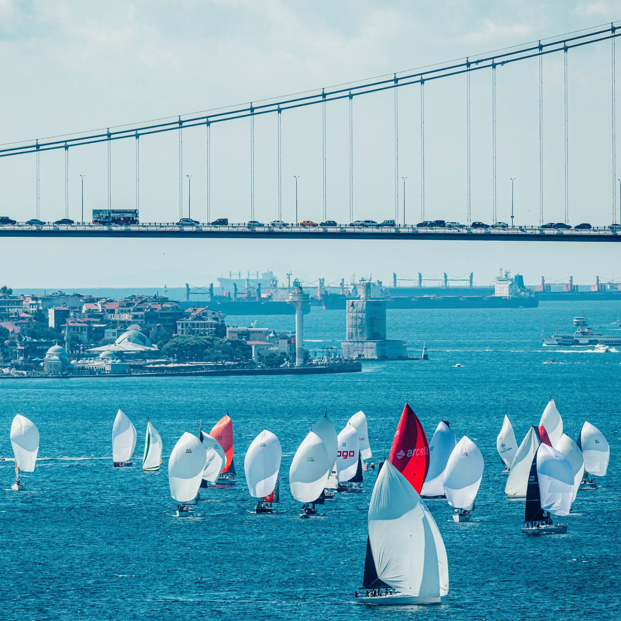 The Bosphorus Cup fleet racing beneath the Bosphorus Bridge.